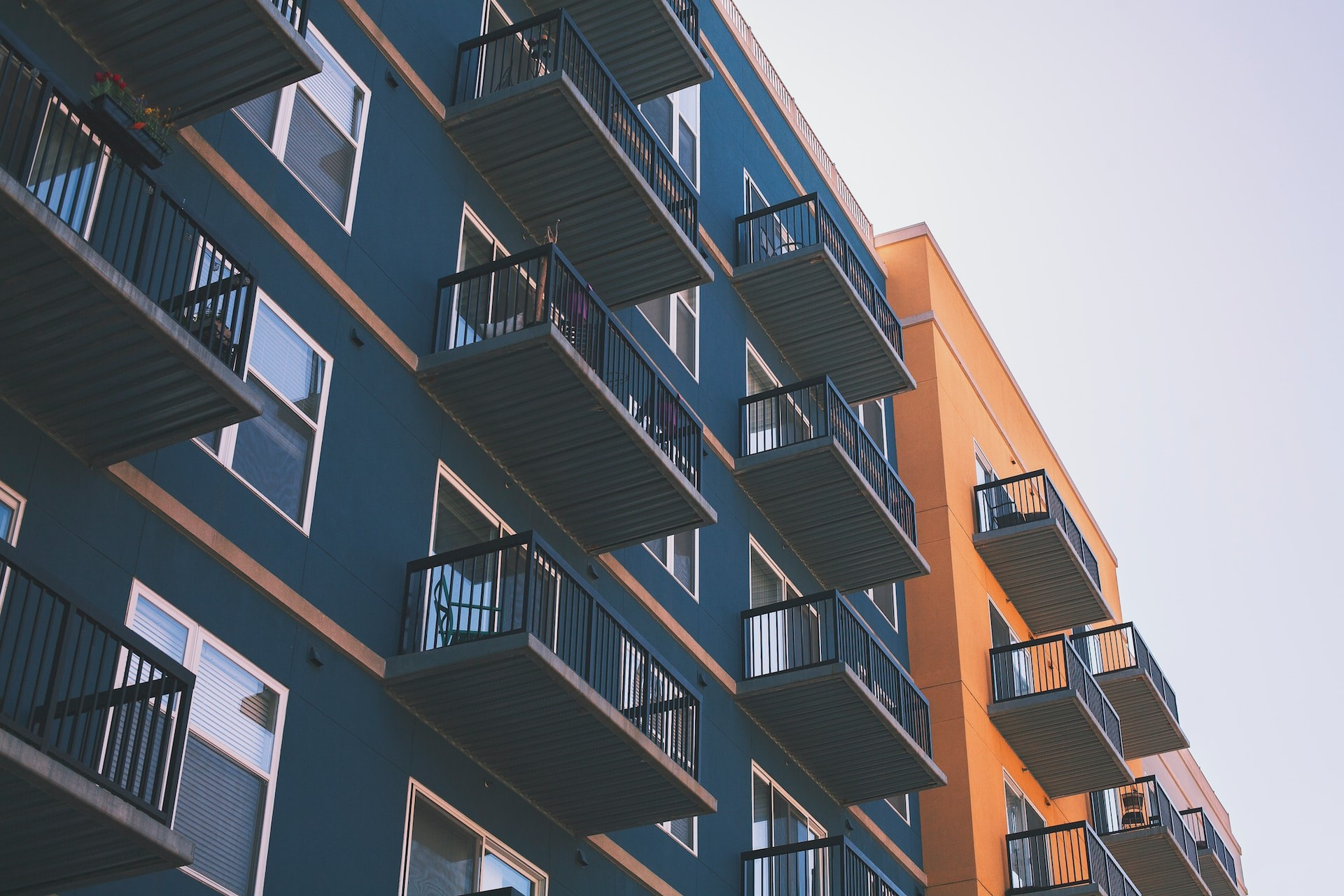 Blue and orange condo building with balconies